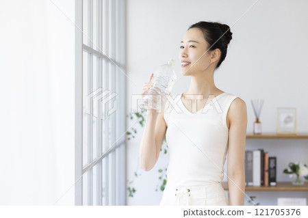 Diet: Woman drinking water from a plastic bottle Diet: Woman drinking water from a plastic bottle 121705376