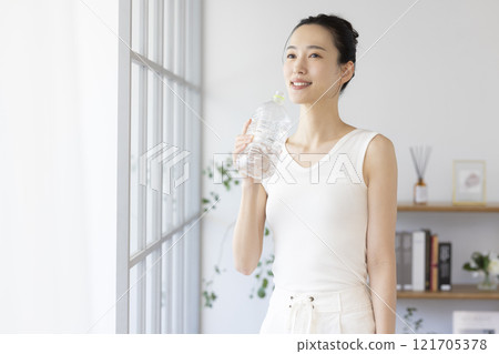 Diet: Woman drinking water from a plastic bottle 121705378