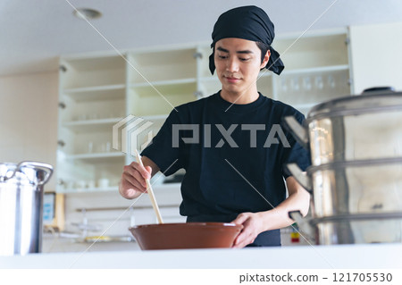 A ramen shop clerk serving ramen in a bowl 121705530