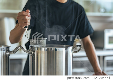 Restaurant clerk boiling noodles in the kitchen 121705531