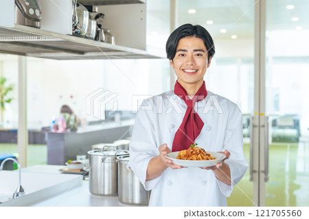 A man wearing a cook coat and carrying food A man wearing a cook coat and carrying food 121705560
