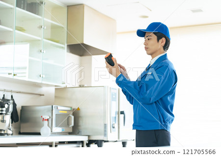 A worker measuring the indoor environment with a portable measuring instrument A worker measuring the indoor environment with a portable measuring instrument 121705566