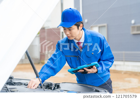 Male worker who opens the hood of the car and inspects it Auto mechanic 121705579