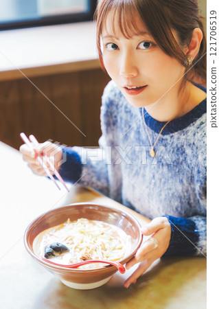 Happy young woman eating delicious ramen Happy young woman eating delicious ramen 121706519