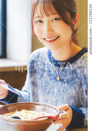 Happy young woman eating delicious ramen Happy young woman eating delicious ramen 121706520
