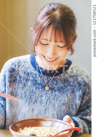 Happy young woman eating delicious ramen Happy young woman eating delicious ramen 121706521