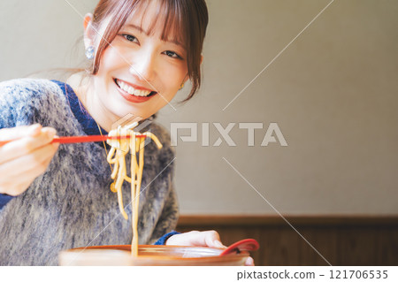 Happy young woman eating delicious ramen Happy young woman eating delicious ramen 121706535