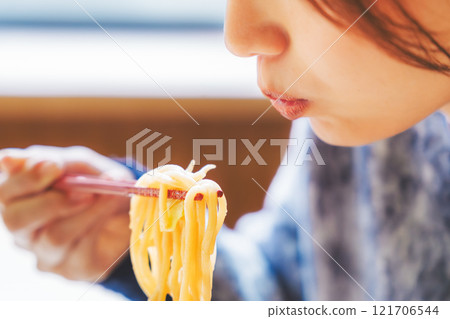 Happy young woman eating delicious ramen Happy young woman eating delicious ramen 121706544