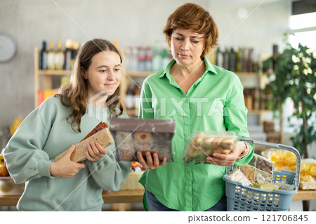 Woman with a child chooses sweets 121706845