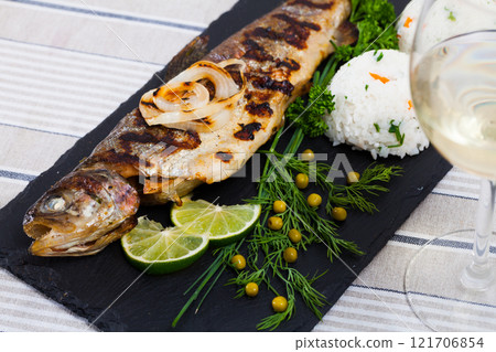 Baked trout with rice and white wine 121706854