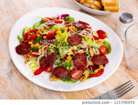 Vitamin salad of fresh vegetables, lettuce leaf, corn, bel pepper and chorizo. 121706959