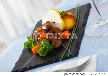 Roasted chicken hearts with baked vegetables, fresh pear 121707154
