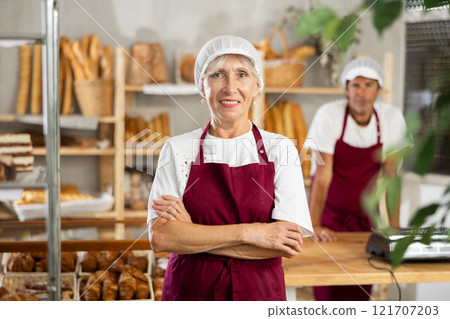 Elderly woman seller posing in bakery 121707203