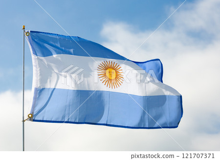 Flag of Argentina waving on cloudy sky during daytime 121707371