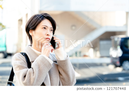 A woman talking on a smartphone 121707448