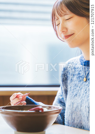 A young woman groans at the deliciousness A young woman groans at the deliciousness 121707915