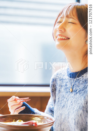 A young woman groans at the deliciousness A young woman groans at the deliciousness 121707916