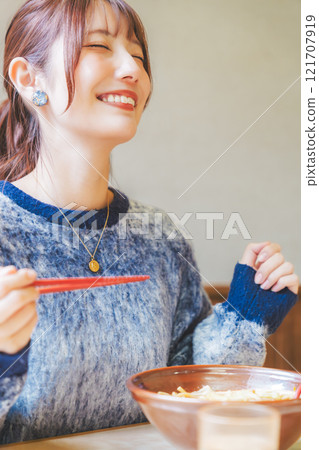 A young woman groans at the deliciousness 121707919