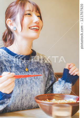 A young woman groans at the deliciousness 121707920