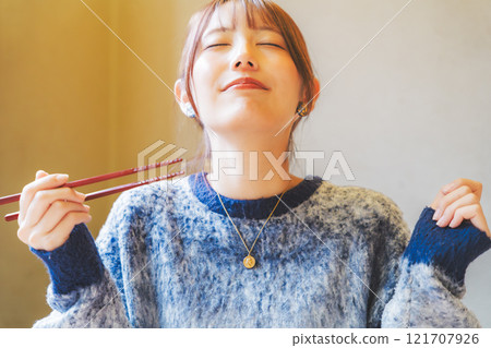 A young woman groans at the deliciousness 121707926