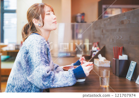 Happy young woman eating delicious ramen Happy young woman eating delicious ramen 121707974