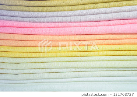 stack of colourful cotton clothes, close up pile of clothing 121708727