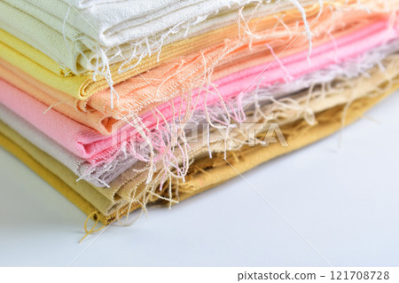 stack of colourful cotton clothes, pile of clothing on white background 121708728