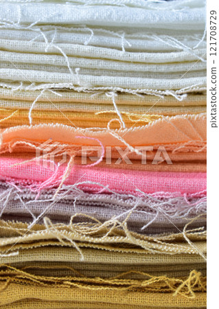 stack of colourful cotton clothes, close up pile of clothing 121708729