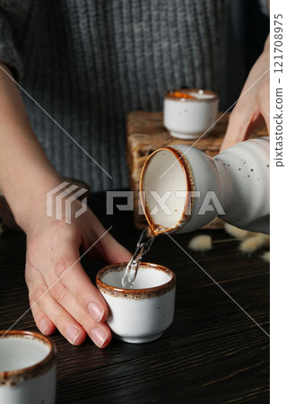 Japanese rice tincture, an alcoholic drink, on a dark background. 121708975