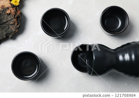 Japanese rice tincture, an alcoholic drink, on a light background. 121708984