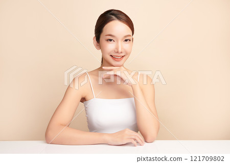 Beautiful young asian woman with clean fresh skin on beige background, Face care, Facial treatment, Cosmetology, beauty and spa, Asian women portrait. Beautiful young asian woman with clean fresh skin on beige background, Face care, Facial treatment, Cosmetology, beauty and spa, Asian women portrait. 121709802
