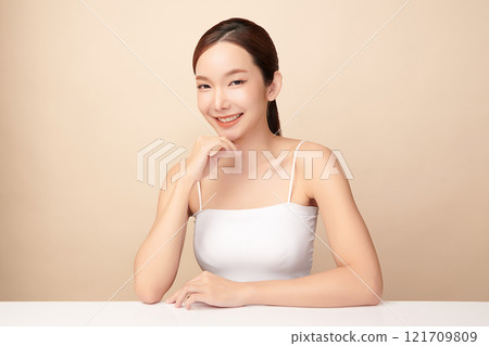 Beautiful young asian woman with clean fresh skin on beige background, Face care, Facial treatment, Cosmetology, beauty and spa, Asian women portrait. Beautiful young asian woman with clean fresh skin on beige background, Face care, Facial treatment, Cosmetology, beauty and spa, Asian women portrait. 121709809