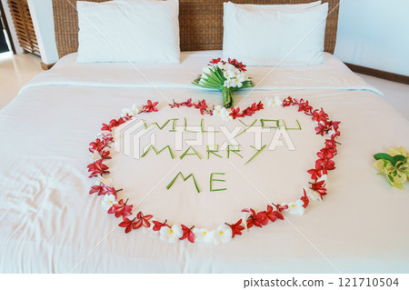 message WILL YOU MARRY ME made of flower petals with bouquet and Heart shape on bed. Idea for marriage proposal, romantic surprise, wedding and engagement concept message WILL YOU MARRY ME made of flower petals with bouquet and Heart shape on bed. Idea for marriage proposal, romantic surprise, wedding and engagement concept 121710504