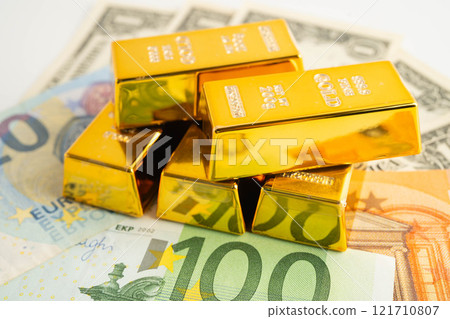 Gold bars with US dollar and Euro banknote money, finance trading investment business currency. 121710807