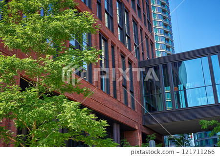 Modern red brick building with green tree in Copenhagen Modern red brick building with green tree in Copenhagen 121711266