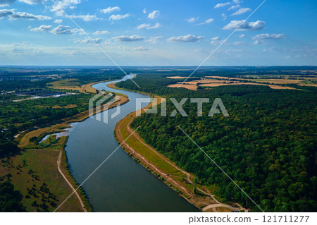 Aerial view of river winding through forest and fields 121711277