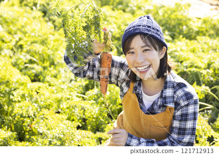 Image of a female farmer working in the fields Image of a female farmer working in the fields 121712913