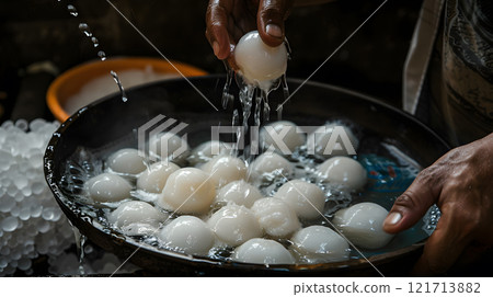 Diwali, Rasgullas being carefully lifted out of sugar 121713882