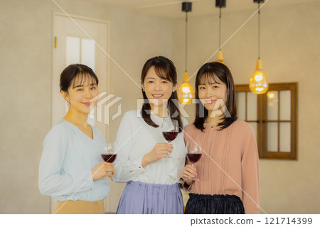 Woman holding a glass of alcohol Woman holding a glass of alcohol 121714399