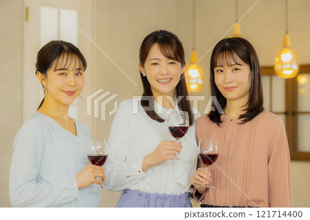 Woman holding a glass of alcohol Woman holding a glass of alcohol 121714400