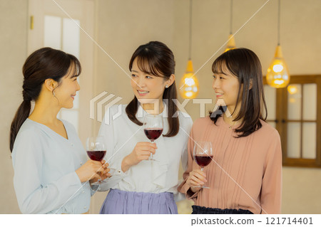 Woman holding a glass of alcohol Woman holding a glass of alcohol 121714401