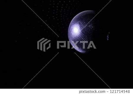 A Disco Ball Shining Red Light, Creating an Energetic Atmosphere Perfect for Celebrating A Disco Ball Shining Red Light, Creating an Energetic Atmosphere Perfect for Celebrating 121714548