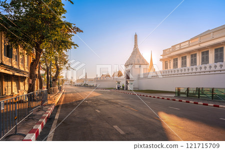 Na Phra Lan Road in front of The Bangkok Grand Palace featuring white walls and traditional architecture under a sunrise sky. 121715709