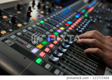This is a professional audio mixing console that features colorful faders for enhanced usability This is a professional audio mixing console that features colorful faders for enhanced usability 121715888