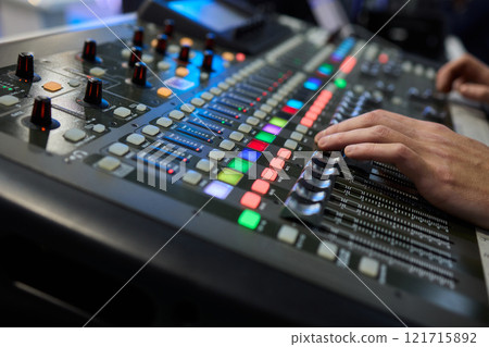 This is a professional audio mixing console that features colorful faders for enhanced usability This is a professional audio mixing console that features colorful faders for enhanced usability 121715892
