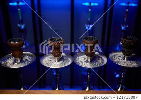 Person holding a hookah at a drinking establishment event Person holding a hookah at a drinking establishment event 121715897