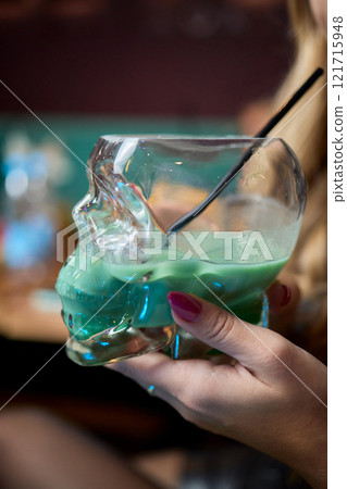 Enjoy a Colorful Cocktail Presented in a Unique and Eye Catching Skull Glass Style Enjoy a Colorful Cocktail Presented in a Unique and Eye Catching Skull Glass Style 121715948