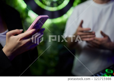 Woman in stylish dress with chic manicure using smartphone in closeup shot Woman in stylish dress with chic manicure using smartphone in closeup shot 121715986