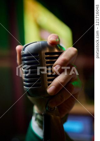 The Iconic Classic Microphone Hand Gesture, Perfectly Captured in a Dynamic and Vibrant Setting The Iconic Classic Microphone Hand Gesture, Perfectly Captured in a Dynamic and Vibrant Setting 121716048