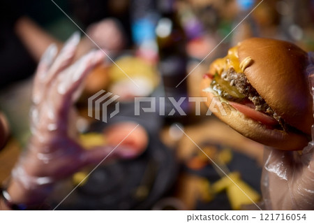 Savor a delicious gourmet burger paired with crispy fries for an unforgettable dining experience 121716054